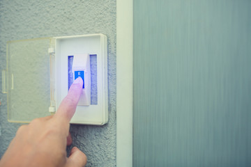 Naklejka premium man push the white exit button on electronic panel. staff push exit button to open door