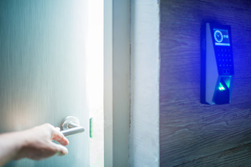 Naklejka premium hand open the door with finger scan access control system to unlock at safe room. blurry image.