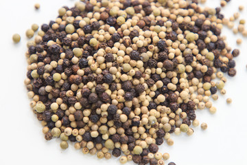 Three colors pepper scattered on white table