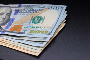 American Dollar Banknotes on black console of car background