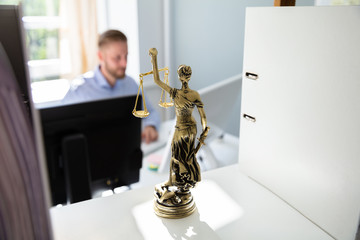 Justice Statue On Shelf At Lawyer Office