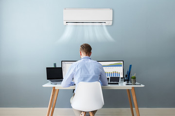 Businessman Working In Office With Air Conditioning