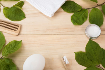 Life in the style of zero waste. Items for personal care and hygiene. Natural materials. Empty space for text. Eco-friendly.  Comb, soap, toothbrush, towel and tooth powder on wooden background. Spa