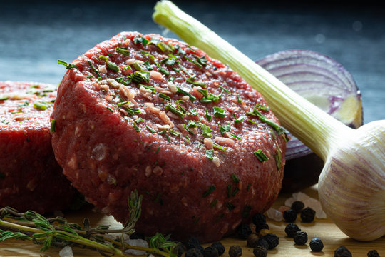 raw organic beaf steak tartare burger patty with onion,garlic,thyme,pepper and himalayan crystal salt