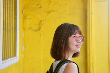 Asian lady female in Melaka Malacca Jonker Street yellow background 