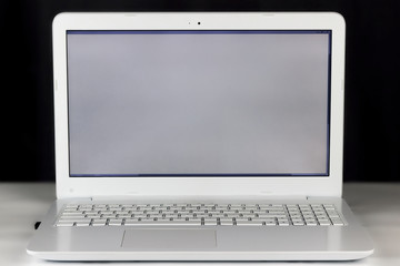 copy spaсe, included, white laptop on a light table, dark background