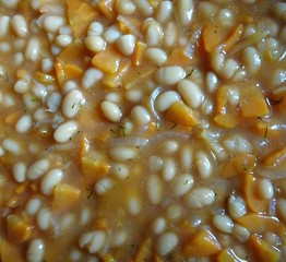 Cooking food white bean beans in sauce with chopped carrot and onion 