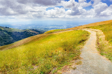 Hiking trail through the hills of south San Francisco bay area, San Jose visible in the background, California