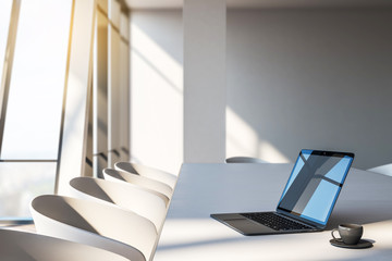 Laptop and coffee in meeting room