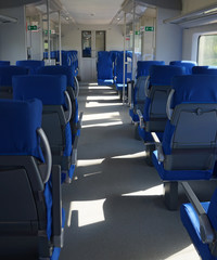 Interior of a modern intercity express train. Back view of wide comfortable seats in row. Empty salon, no people. Travel concept