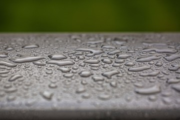 Beautiful background texture of rain water drops on grey black metal surface. Beautiful backgrounds.