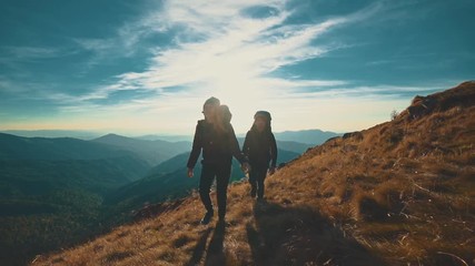 The couple walking along the evening mountain. slow motion