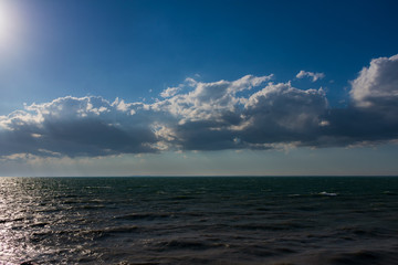 Clouds over water. Clouds against a blue sky. Blue sky with clouds on a sunny day.