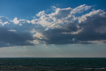 Clouds over water. Clouds against a blue sky. Blue sky with clouds on a sunny day.