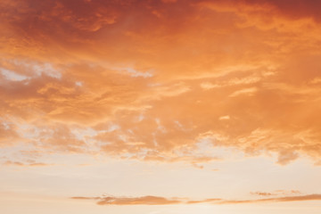 Obraz premium Orange red sunset with clouds in summer
