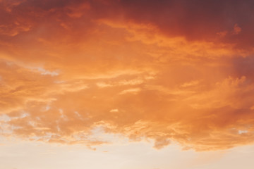 Orange red sunset with clouds in summer