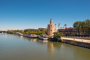 Golden tower Torre del Oro along the Guadalquivir river, Seville Andalusia , Spain .