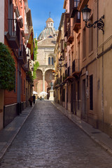 Fototapeta na wymiar Wide street of Santo Domingo leading to the ancient church and statue of Friar Louis of Granada