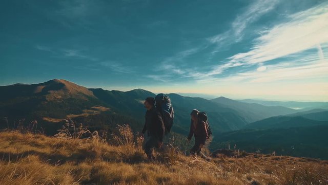 The couple walking to the mountain. slow motion