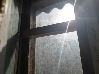 Light in the window. Sunbeam and old window.