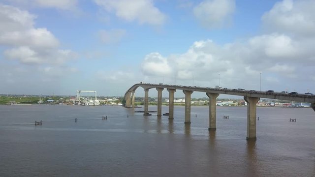 Wide angle aerial shot of Jules Wijdenbosch Bridge between Paramaribo and Meerzorg in Suriname, South America, with heavy traffic.