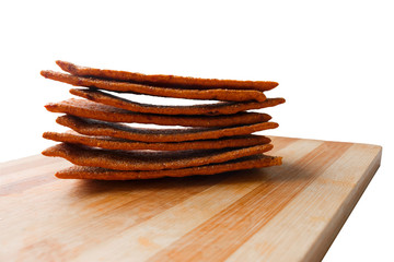 gluten-free bread on a wooden kitchen cutting board, isolated on the white background.