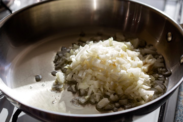 Frying chopped onion in pan