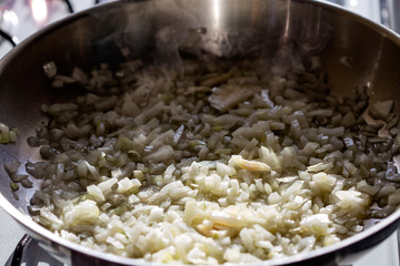 Frying chopped onion in pan