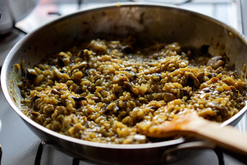 Cooking rice with mushrooms and fried onion