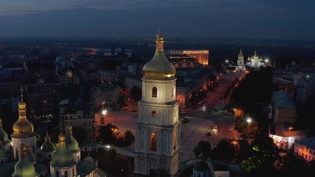 Aerial view of the St. Sophia Cathedral, illuminated at night, the monument to Bogdan Khmelnitsky and the center of Kiev