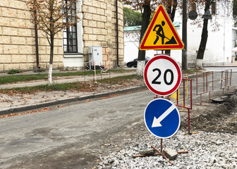 road signs speed limit, repair and detour signs near the pit on the road of European city
