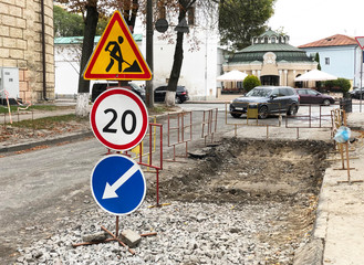Road work warning signs and barriers during asphalt pavement repair. Traffic signs. Roadwork. Traffic Marking of detours..