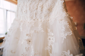 Fototapeta na wymiar white lace embroidered with stones and rhinestones. luxury wedding dress.