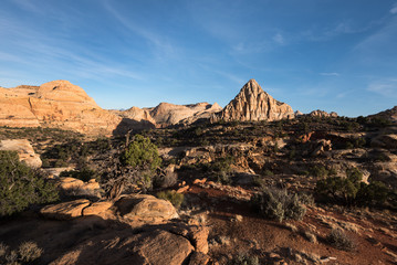 Pectols Pyramid is a prominent rock formation that is located with in Capital Reef National Park, Utah. Late afternoon light and shadows add to the dramatic landscape of the Utah desert.