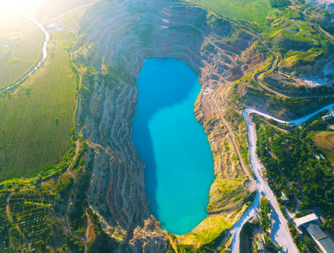 Aerial View Of Opencast Mining Quarry With Lots Of Machinery At Work - View From Above. 