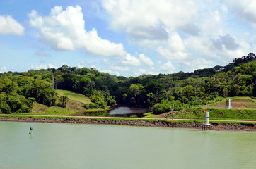 Green landscape of the Panama Canal, view from transiting container ship.