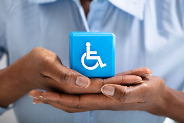 Human Protecting Cubic Block With Disabled Handicap Icon