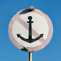Closeup of a special mark for ships. Parking in this place is prohibited. Crossed anchor in a...