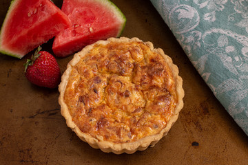Quiche with watermelon on dark background