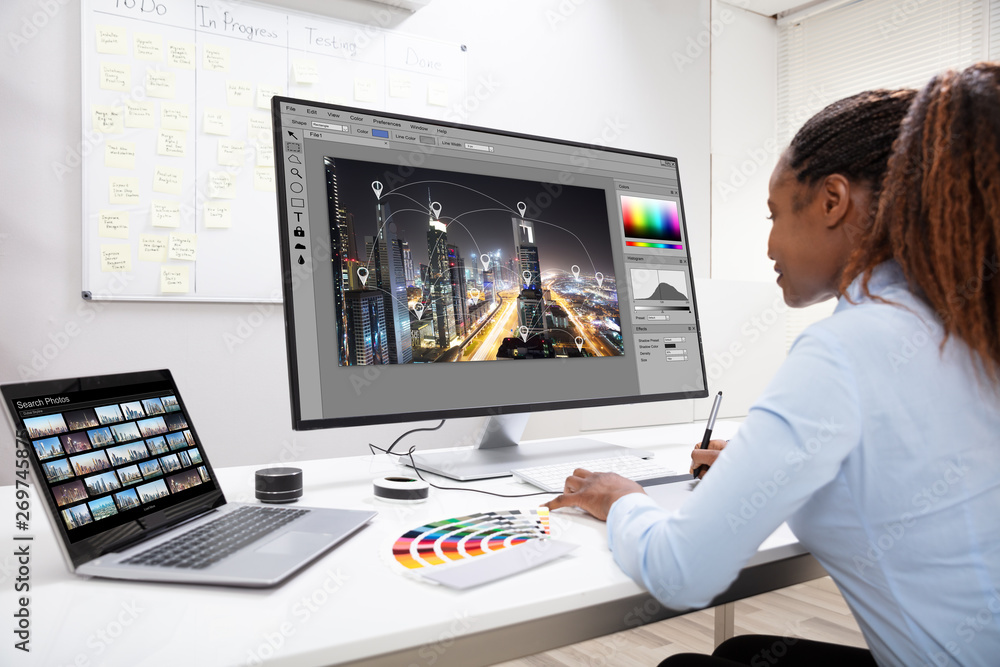 Poster designer editing photos on computer