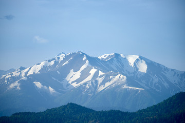 Fototapeta na wymiar Snow-capped peaks of the North Caucasus at sunrise.