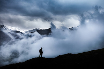 Girl travelling through beautiful epic mountain landscape