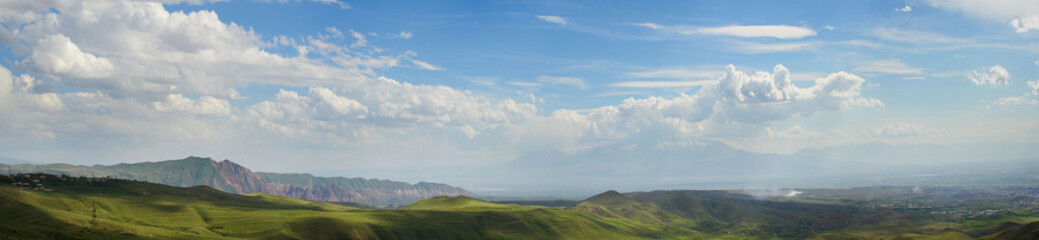 Fototapeta premium Landscape with mountains on background and cloudy sky, panorama