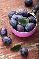 plums on the table on a shabby background