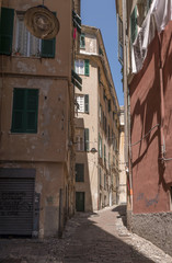 high buildings and narrow alley  in sea town historical center, Genova, Italy