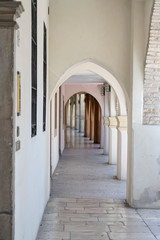 Fototapeta na wymiar narrow arched covered walkway, Portogruaro , Italy