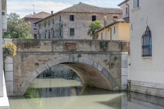 stone bridge on Lemene river, Portogruaro , Italy