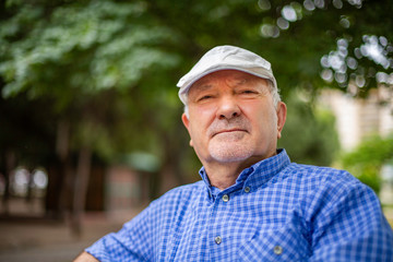 An old (elderly) man with grey hair 