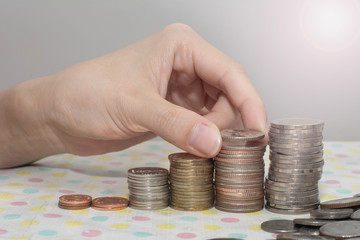 Saving money concept preset by Female hand putting money coin stack growing business isolated on white, Money, Financial, Business Growth concepts