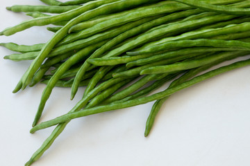 Bunch of green beans lying on a light table